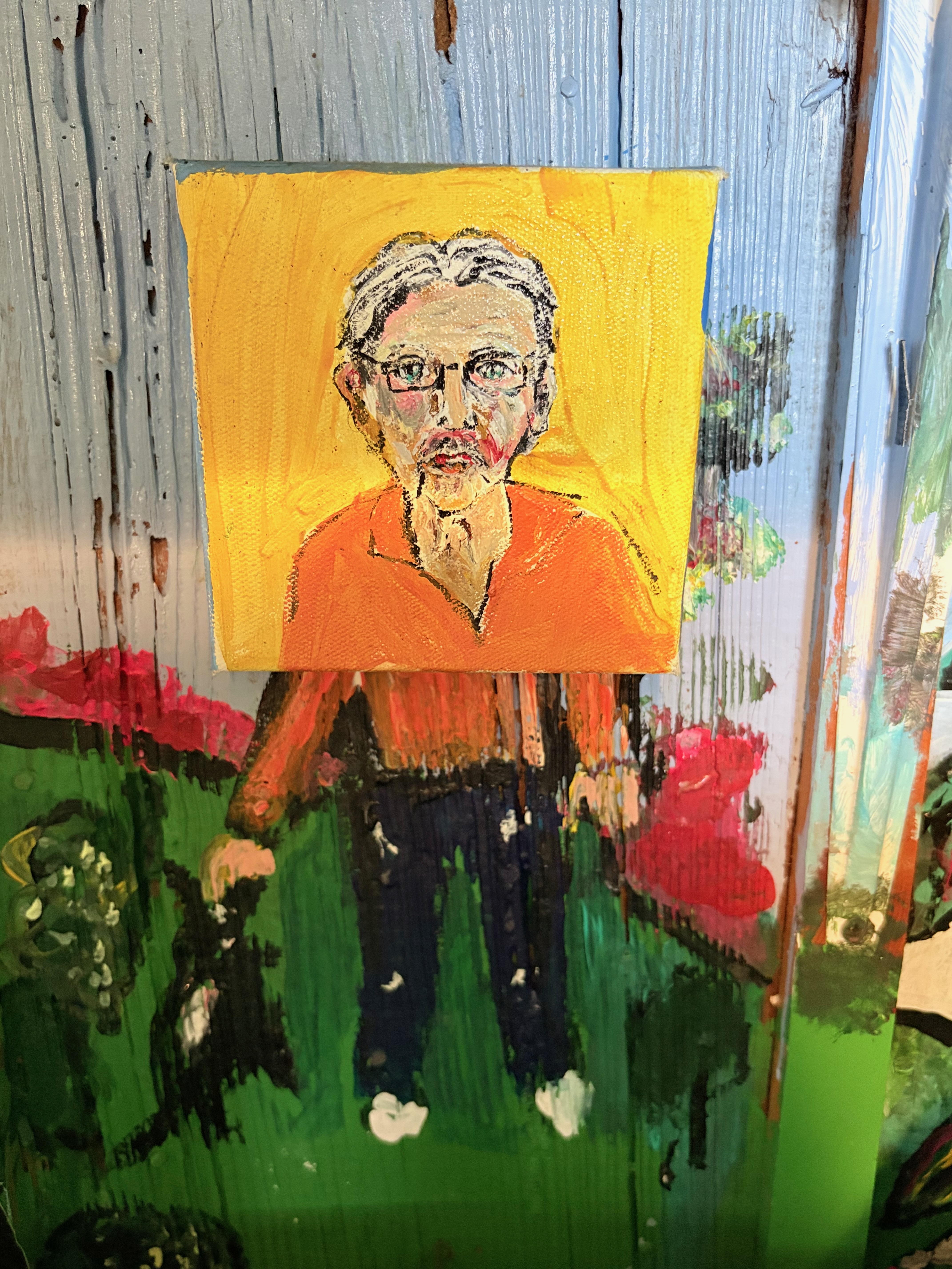 Self-portrait painted on fence boards