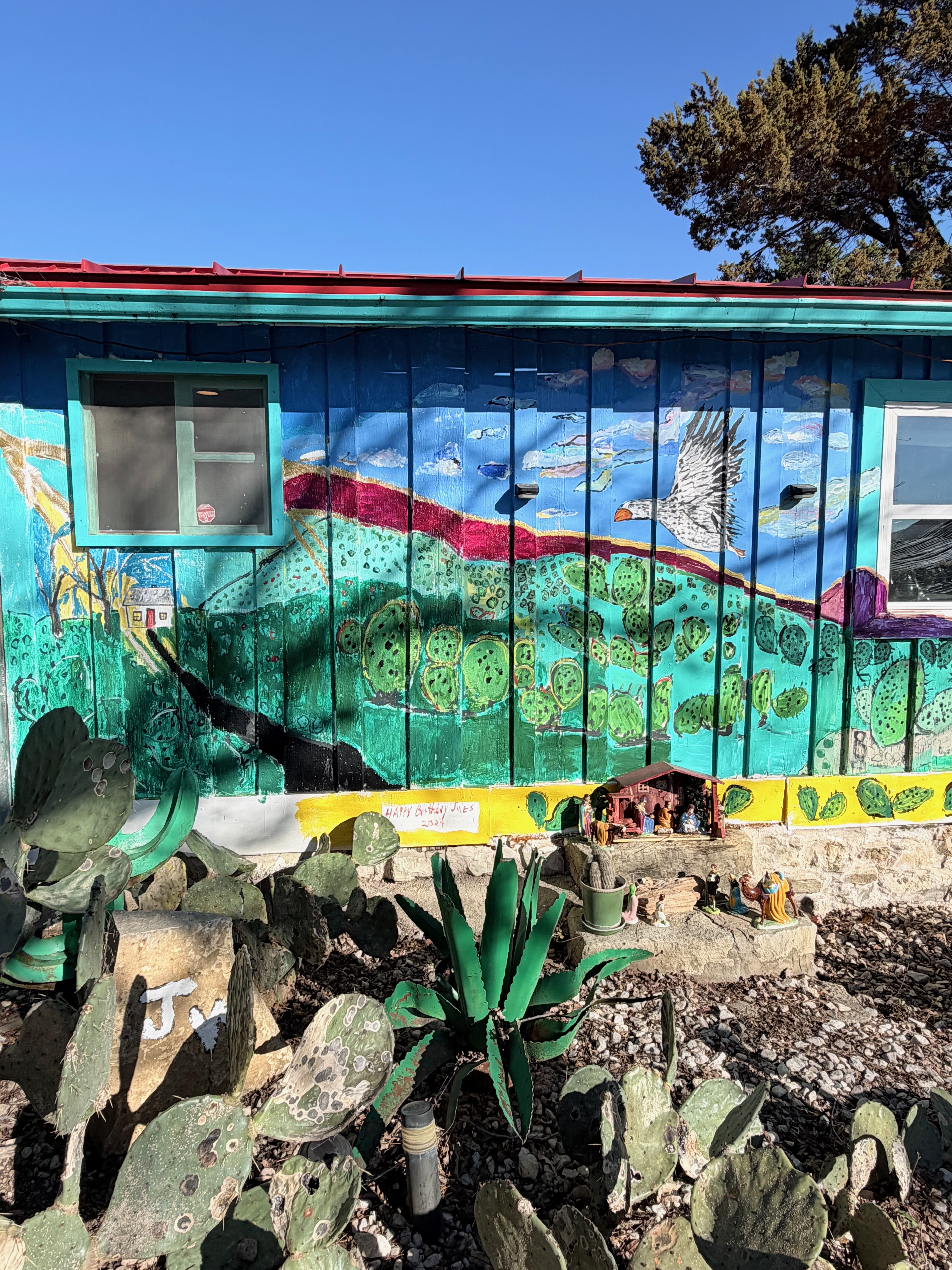 Exterior mural — bird over cactus landscape